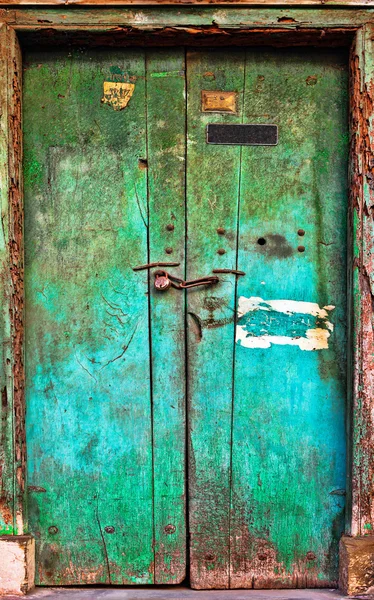 Old dilapidated wooden door.