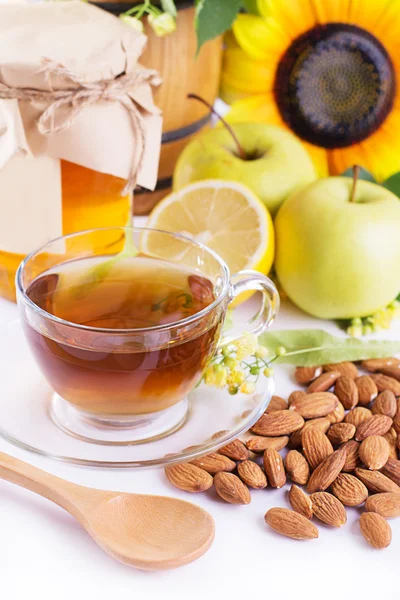 Cup of tea with linden honey, apples, almonds