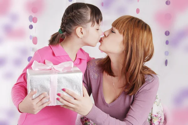 Mother and daughter kissing