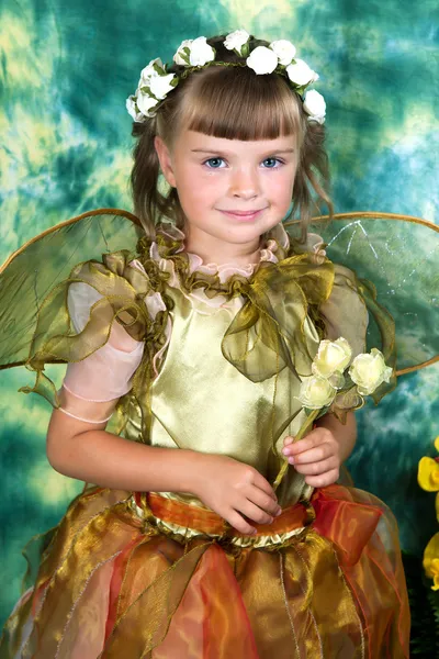 Beautiful girl in a green dress with wings in a wreath on a gree