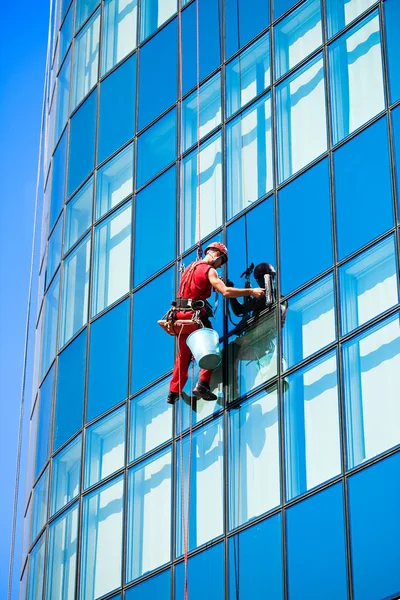 Window washer cleaning windows