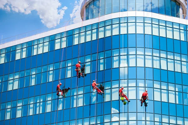 Workers washing windows in the office building