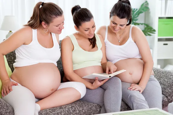 Pregnant women reading a book