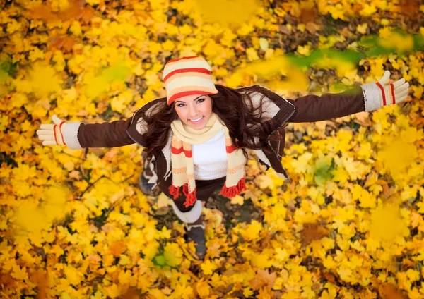 Happy woman playing in autumn