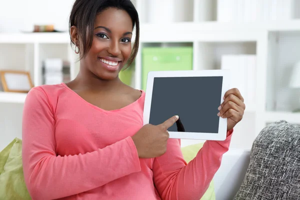 Cheerful woman showing digital tablet