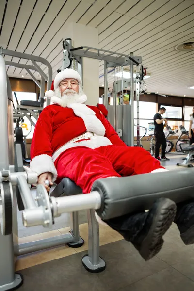 Father Christmas doing exercises in gym