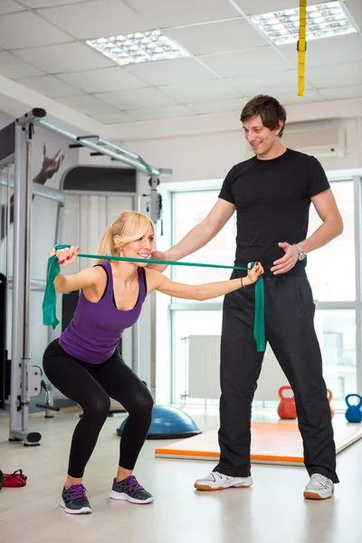 Woman exercising with personal trainer