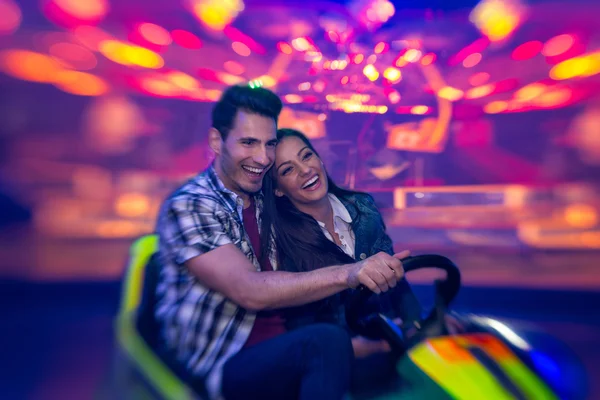 Laughing couple in bumper car - shoot with lensbaby