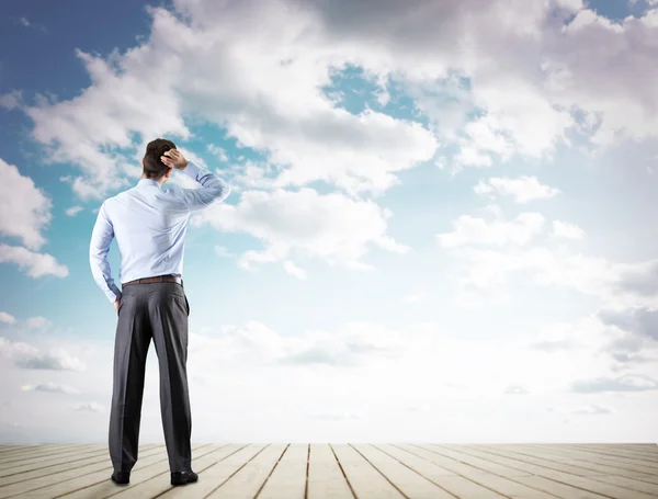 Businessman looking at sky