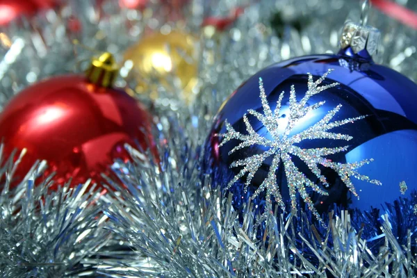 Three christmas glass spheres and a tinsel