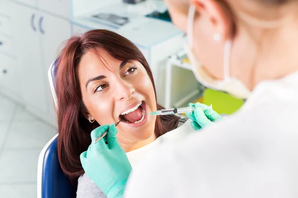 Giving anesthesia to the patient before dental surgery