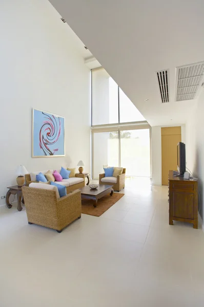 Panoramic view of nice light living room. Image on the wall was changed.