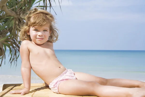 Portrait of nice little girl having fun on the beach