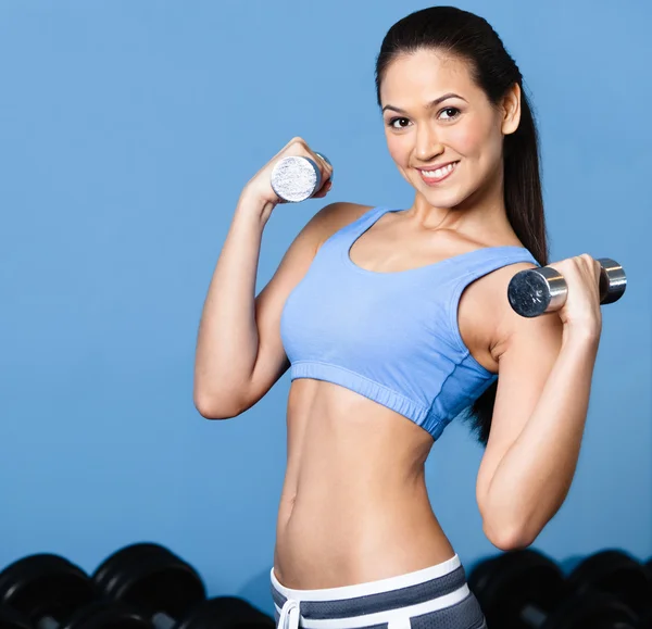 Woman exercises with dumbbells