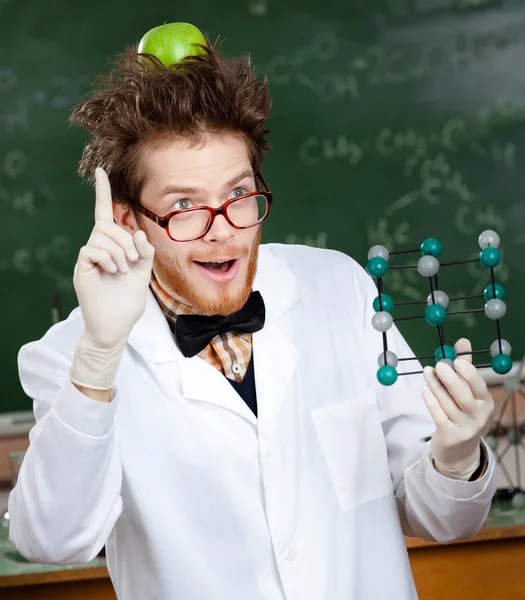 Mad scientist with an apple on his head shows forefinger while handing mole