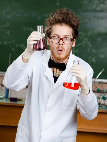 Mad scientist shows two flasks