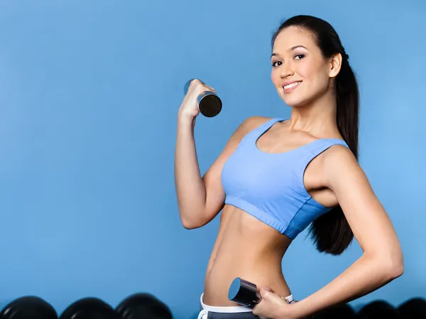 Woman works out with dumbbells