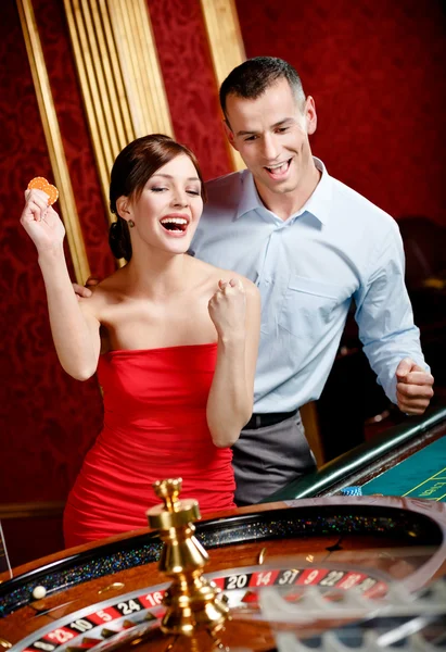 Happy couple playing roulette wins