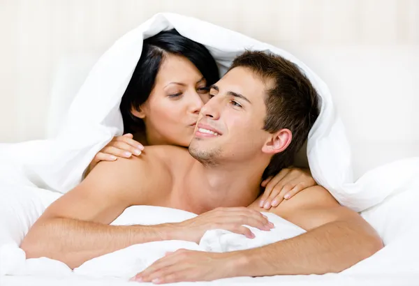 Close up view of couple playing in bedroom