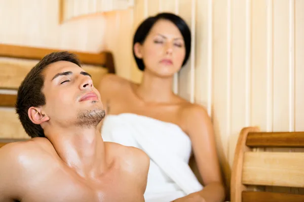 Half-naked man and girl relaxing in sauna — Stock Photo #24412579