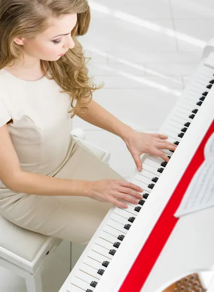 Top view of musician playing piano