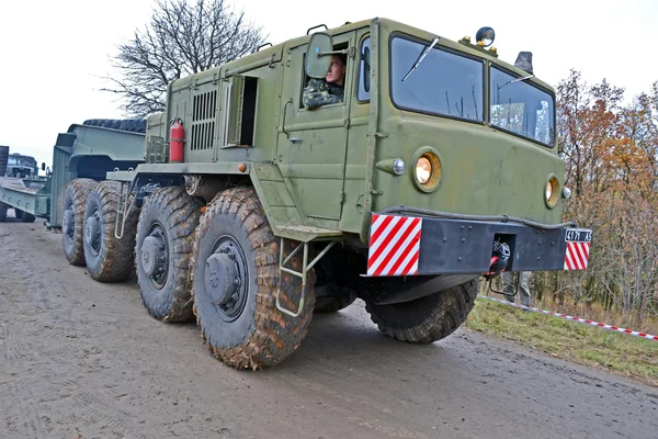 Strong military tractor on the road, special transportation details.