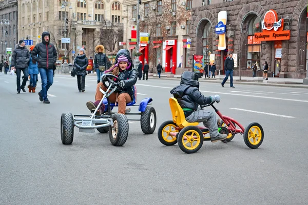 Kids (children) on Kreshatik during Woman sport car show in Kiev, Ukraine.