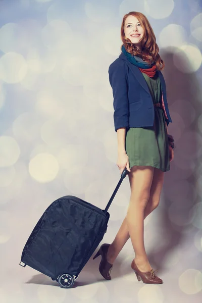 Redhead girl with a suitcase