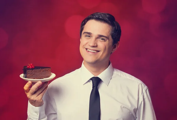 Man holds cake, on red background — Stock Photo #34663975