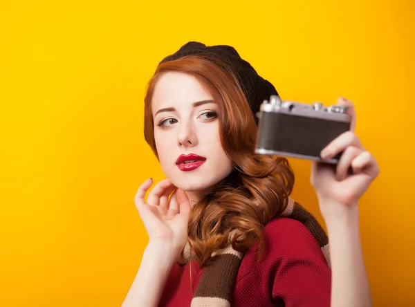 Redhead women with scarf and vintage camera