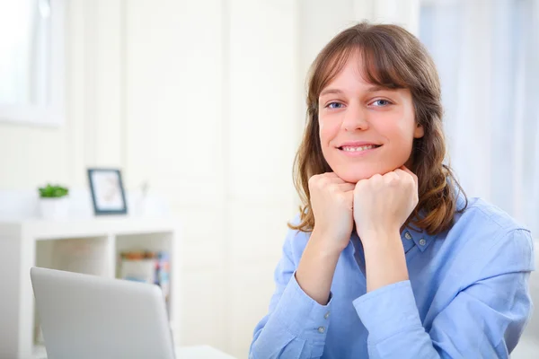 Portrait of young smiling business woman at work