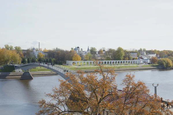 View of the Yaroslav courtyard and pedestrian bridge over the Volkhov river autumn day. Veliky Novgorod