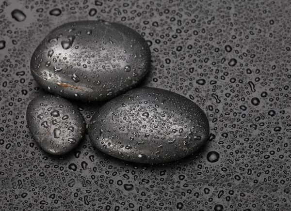 Black stones with water drops