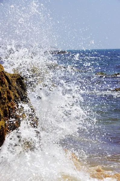 Spray of waves crashing against rock