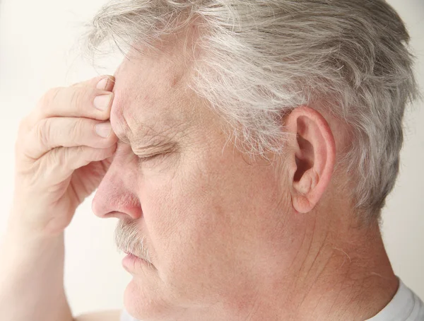 Man with headache over eye