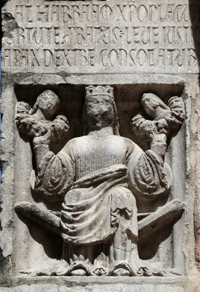 Faith (holding Justice and Peace) relief at the baptistry from Parma, Italy