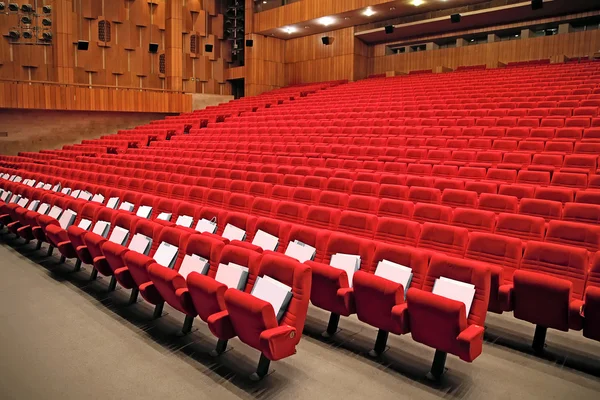 Interior of empty hall with red arm-chairs