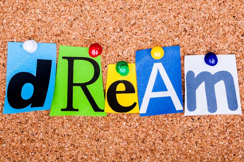 The word Dream in cut out magazine letters pinned to a cork noti