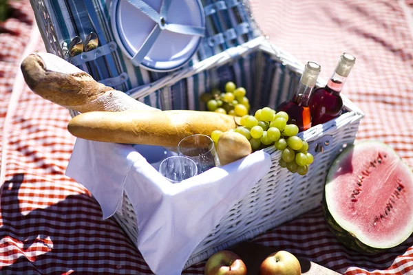 Picnic basket with fruit bread and wine