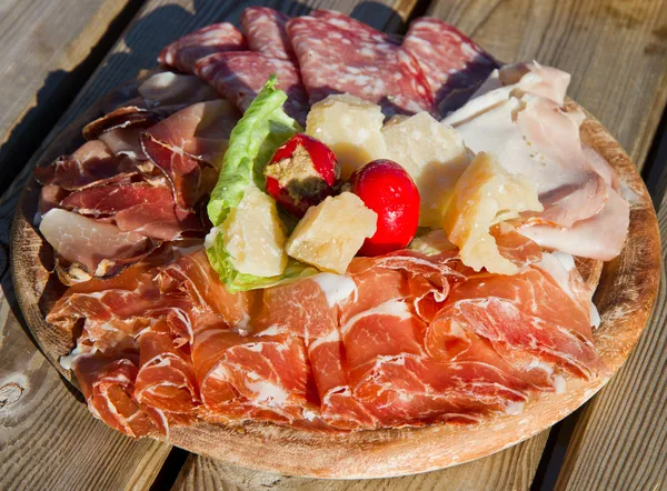 A platter of mixed cured meats, cheese