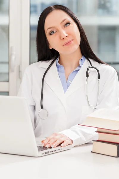 Female doctor is studying with books