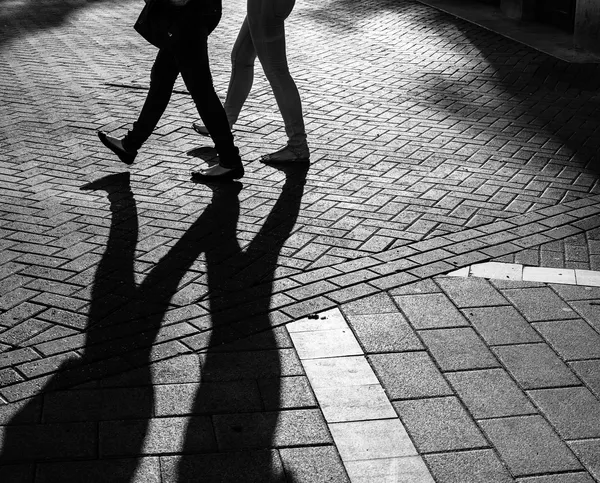Shadows of people walking street