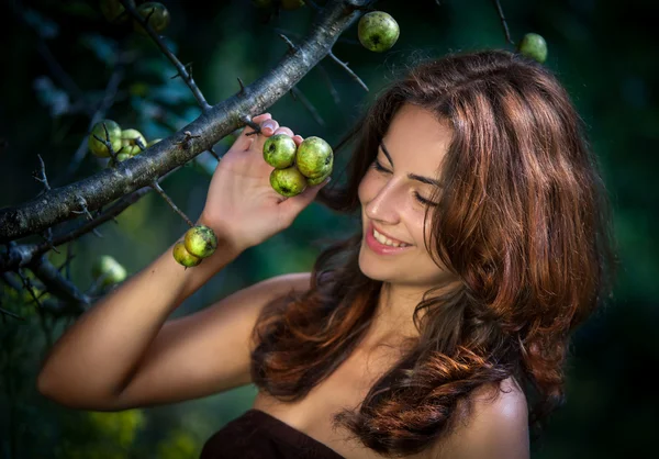 Young woman with wild apples