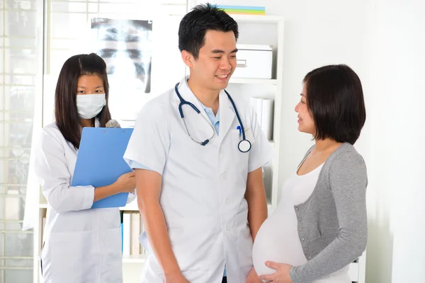 Asian doctor performing pregnancy medical check up