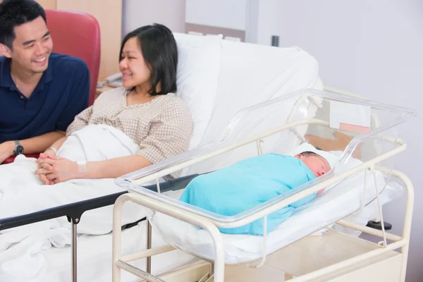 Asian chinese family with newborn baby in the hospital