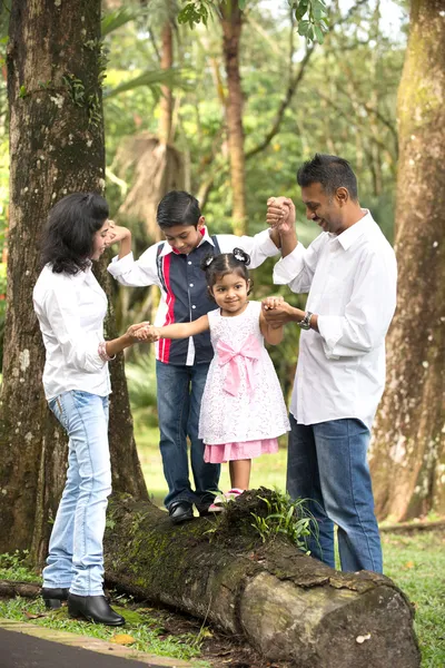 Indian family teaching children to climb