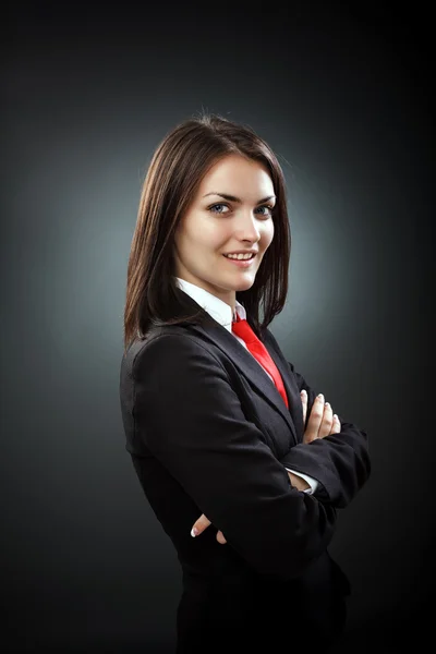 Happy young businesswoman wearing suit and necktie, isolated on