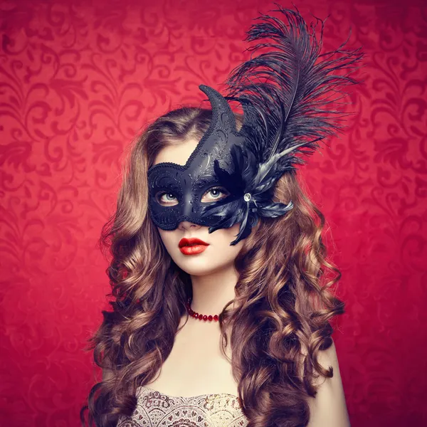 Beautiful young woman in black mysterious  Venetian mask