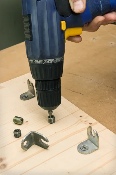 Fastening with an screwdriver furniture parts