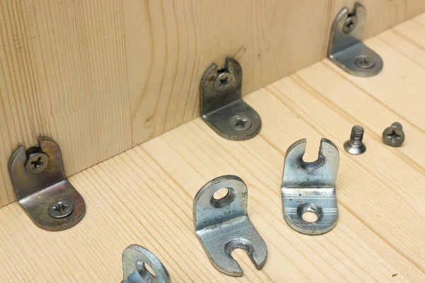 Fastening metal details at manufacturing wooden furniture